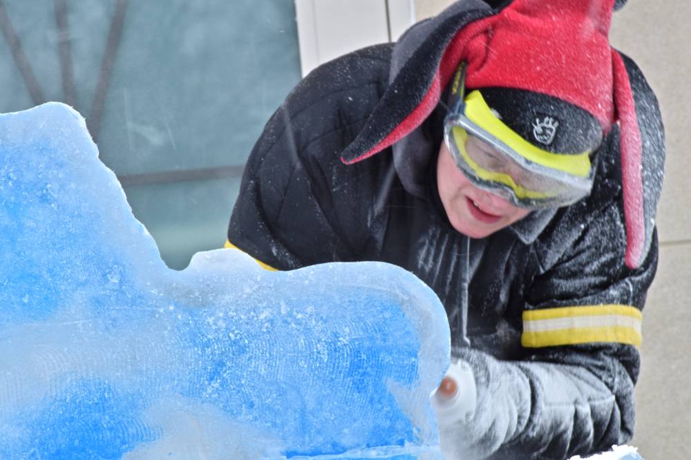 person working on ice sculpture